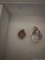 Square pink stone charm and clear heart charm in box