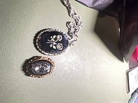 Pendant necklace and cameo brooch side by side