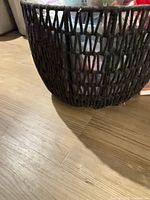 Side view of black woven cotton rope basket showing weave pattern