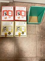 All four boxed baby handprint photo frames plus cardboard divider