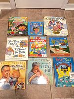All nine children’s books laid out in three-by-three grid