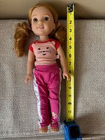 Full view of doll with tape measure showing height about 14 inches