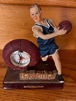 Front view of figurine, basketball clock, base details
