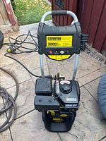 Front view of Champion 3000 PSI pressure washer showing control panel, engine, frame and wheels