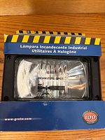 Front of boxed Grote Work Zone halogen work lamp showing clear lens and beam type spot marking
