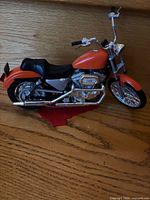Left profile of orange Harley-Davidson 1200 die-cast model motorcycle