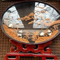 Full view of cork diorama with pandas in wood frame and stand