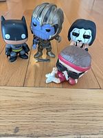 All four Funko Pop figures standing on floor