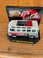 Front angle of die-cast VW Transporter on base with backdrop