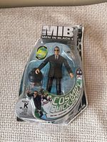 Front of sealed Agent K Cosmic Quick-Shift figure packaging