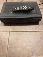 Top view of Scientific Atlanta Explorer 4290 with remote resting on grille