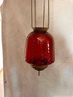 Full view of cranberry glass hall lamp hanging