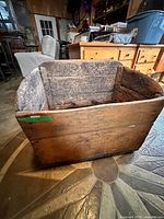 Front view of antique pine firewood box showing wood plank front and curved sides