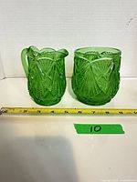 creamer and spooner shown with measuring tape for scale