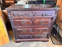 Front view showing all four drawers, hardware, overall style