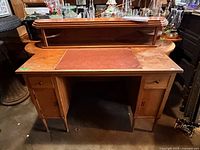 Front view showing full desk with raised shelf and leather blotter