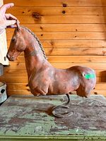 Full view of cement horse bust on base