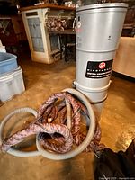 Full view of Hoover WindTunnel central vacuum unit with hose