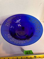 Top view showing cobalt blue bowl, gold floral scroll on rim
