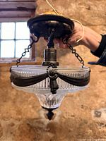 Full view of cut glass pendant light showing shade, canopy, chains, wiring