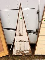 Full view of front side showing triangular frame and distressed door panels