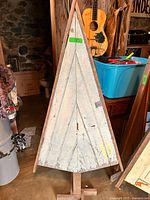 Full view of triangular wooden Christmas tree on base