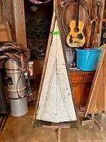Full view of repurposed door Christmas tree with crackled white front, wood frame, and base