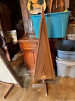 Full view of wooden triangular tree on stand