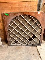 Full view of arched wooden diamond sash window