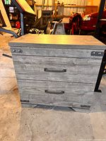 Front view showing two drawers, metal handles, corner brackets
