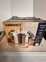 Box front showing Mirro 12-quart pressure cooker/canner image and capacity details