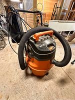 Full view of Ridgid wet/dry vacuum with hose and attachment bag