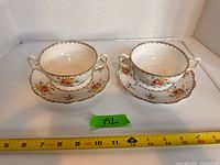 Front view of both handled cups on saucers