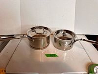 Both saucepans with lids side by side