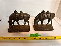 Pair of cast iron horse bookends with measuring tape for scale