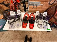 Top view of three pairs of Tubbs youth snowshoes on table