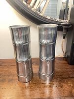 Both metal faux bamboo candlestick holders side by side