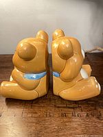 Side view of both ceramic teddy bear bookends back to back