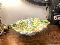 Full view of Fitz & Floyd leaf-shaped accent bowl on table
