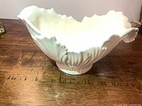 Side view showing scalloped rim and fluted body