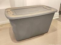Front three-quarter view of one grey storage bin with lid attached
