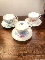 All three teacup and saucer sets on table