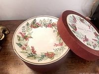 Box displaying one plate with berry wreath design