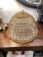 Full view of rattan food cover dome on tabletop