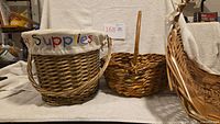 Group view of three wicker baskets showing shapes and handles