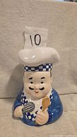 Front view of chef baker ceramic cookie jar with removable hat lid
