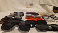 Front view showing variety of sunglasses laid out