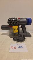Dyson V8 vacuum main body side view with charger cable
