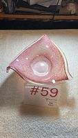 oblique view of triangular pink Murano bowl showing clear rim and interior texture