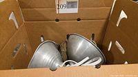 Two aluminum reflector clamp lights in a cardboard box